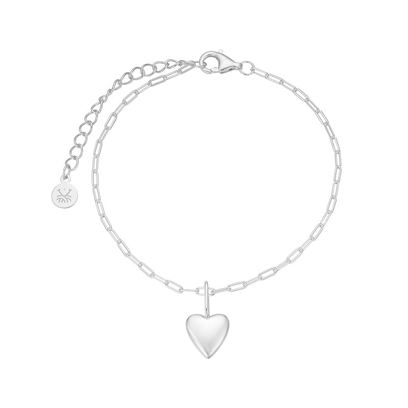 Silver bracelet with a heart-shaped pendant on a white background