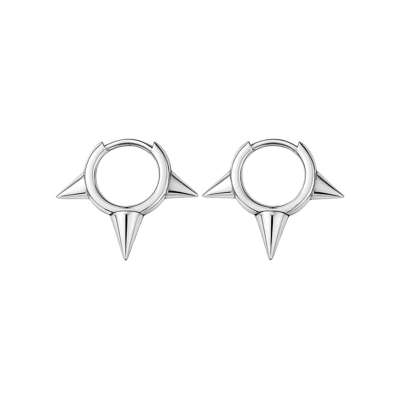 Pair of silver spike earrings on a white background — jewellery detail
