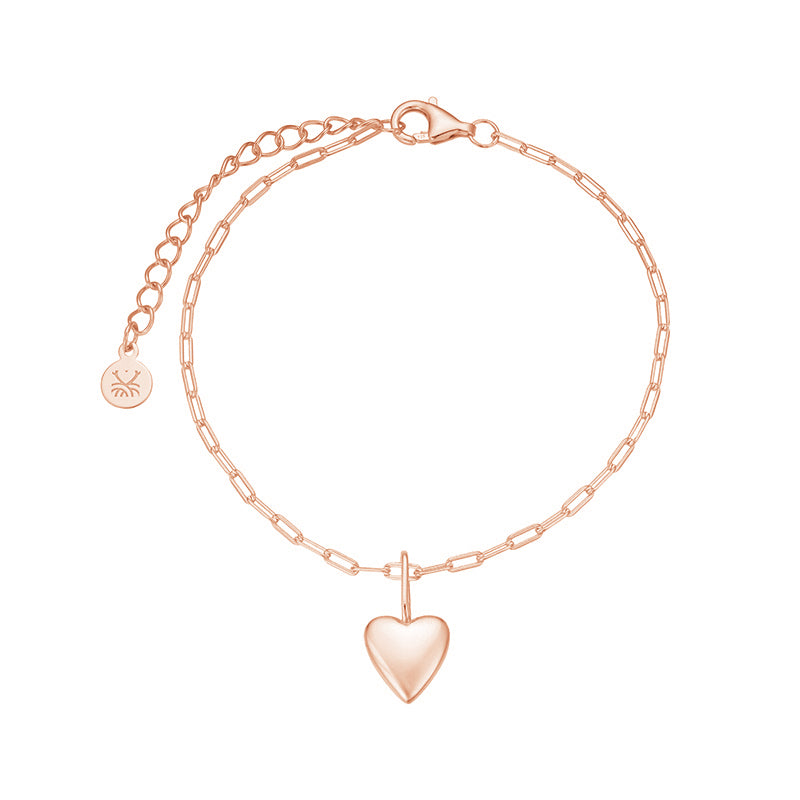 Rose gold bracelet with a heart-shaped pendant on a white background